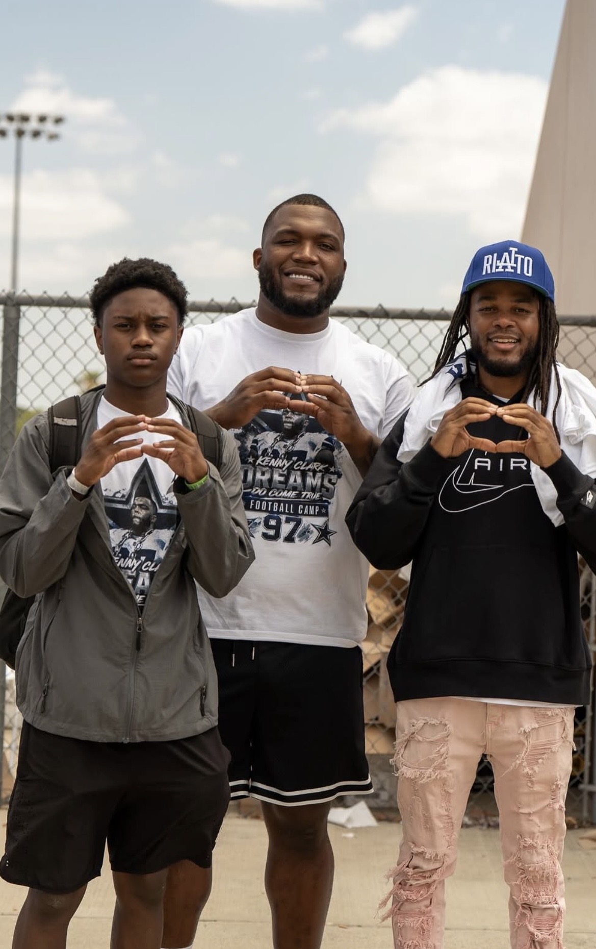Jamirre Mooring, Kenny Clark, and Jerrion Gilmore throwing up the U